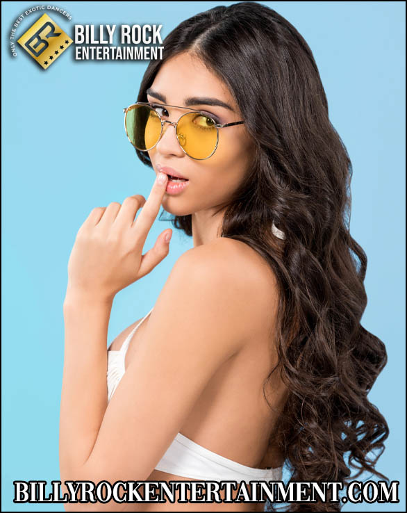Vanessa Vixen posing playfully with yellow sunglasses and long dark brown hair.
