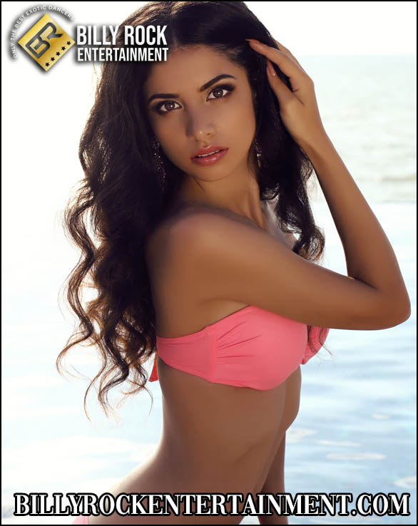 Isabella Ivy by the ocean in a pink bikini top.