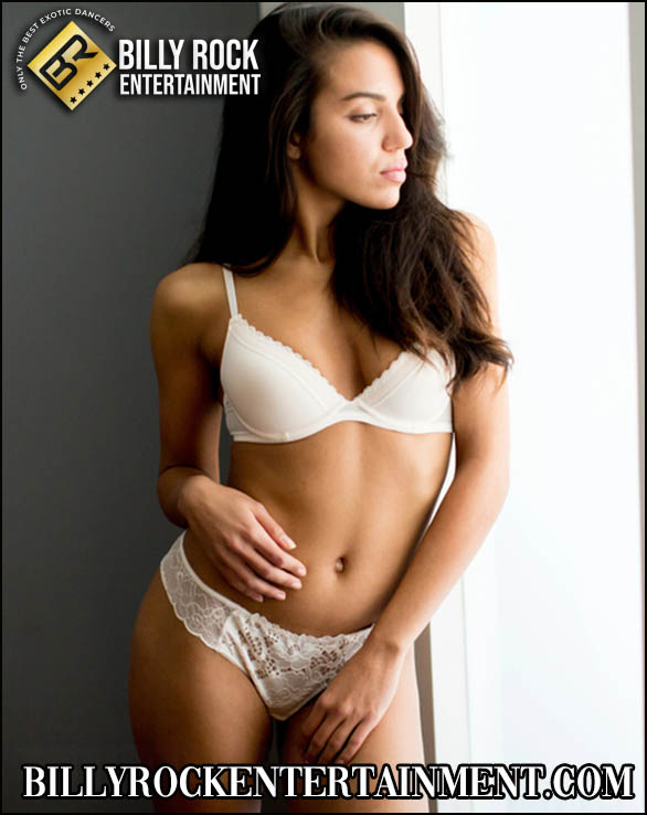 Marina standing serenely in white lingerie.