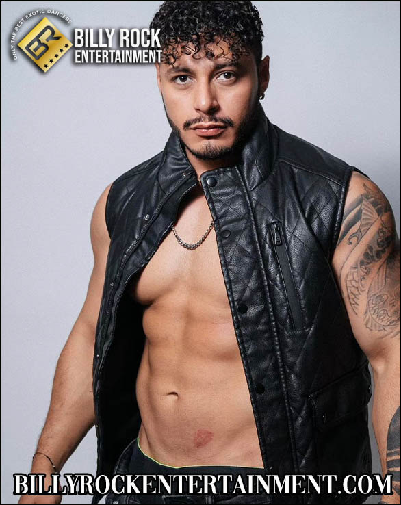 Casta: Toned, tattooed, black leather vest, necklace.