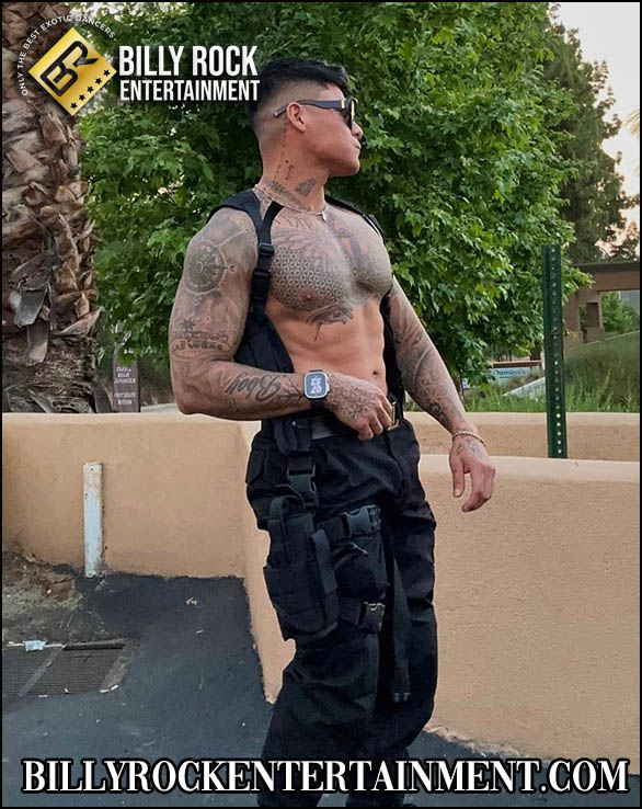 Joe: Shirtless male dancer with tattoos and sunglasses, outdoor setting with vegetation.