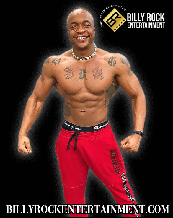 Sensation: Shirtless, muscular, tattoos, red sweatpants, smiling, chain necklace, black background.