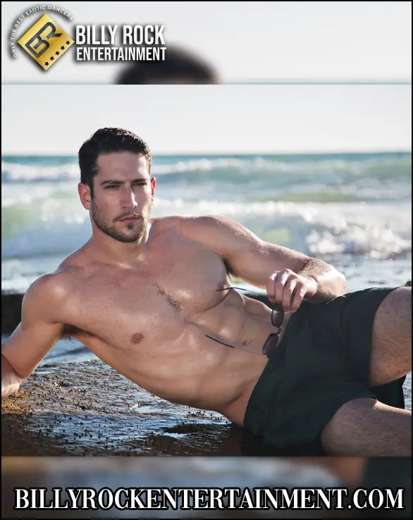 Nick Flow, muscular Los Angeles male stripper posing shirtless on a Southern California beach.